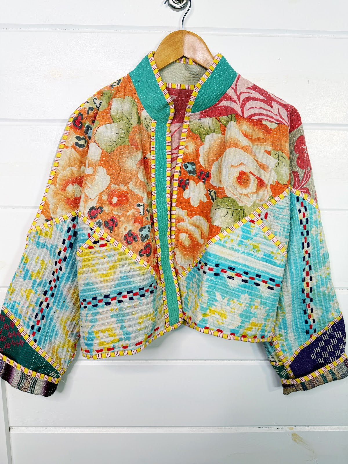 Stevie style revival kantha jacket #2313, on a hanger, front view with sleeves out