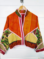 Stevie style revival kantha jacket #2314, on a hanger, front view with sleeves out