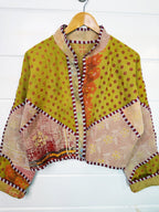 Stevie style revival kantha jacket #2309, on a hanger, front view with sleeves out