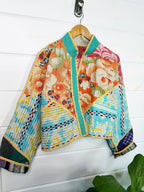 Stevie style revival kantha jacket #2313, patchwork kantha on a hanger, front view