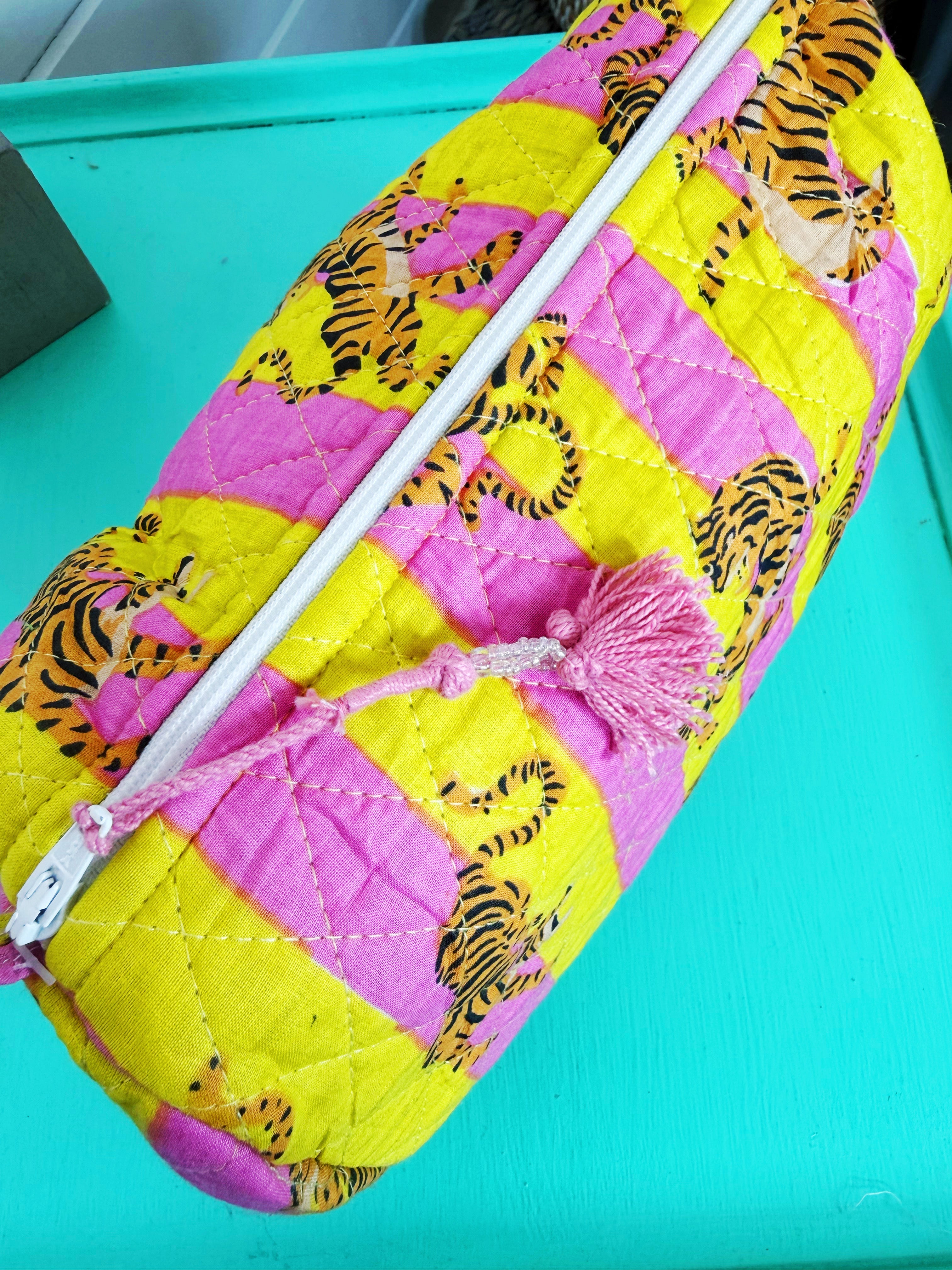 Colorful quilted bag with tiger pattern on a turquoise background