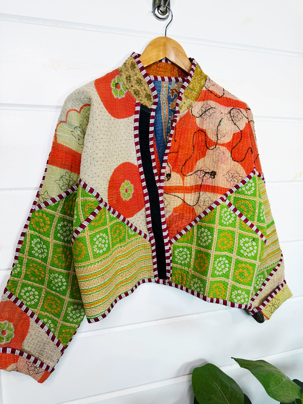 Stevie style revival kantha jacket #2302, in orange and green patchwork kantha on a hanger, front view