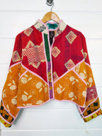 Stevie style revival kantha jacket #2303, on a hanger, front view with sleeves out
