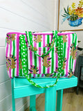 Pink and Green Jaguar print quilted weekender bag, on a stand, front view